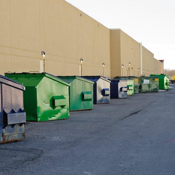 commercial dumpster with recycling symbol on the side